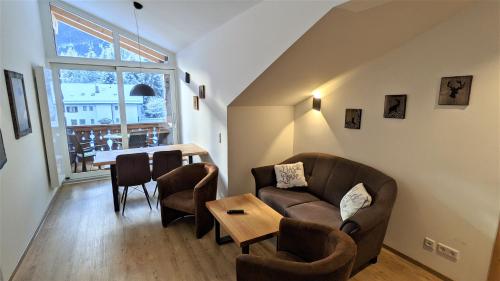 a living room with a couch and a table at Ferienhaus Wetterstein in Grainau