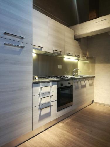 a kitchen with white cabinets and a stove top oven at Hotel Centrale in Bologna