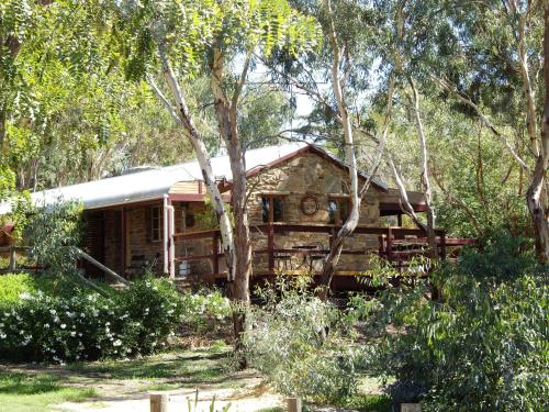 a house in the middle of some trees at 1860 Wine Country Cottages in Springton