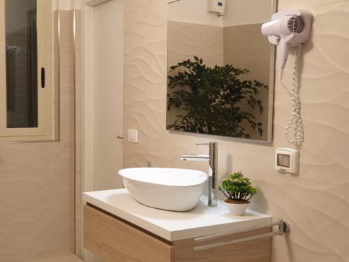 a bathroom with a white bowl sink on a counter at Terra di Venere Inn in Ragusa