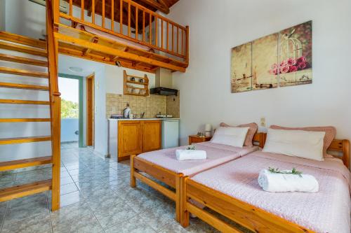 a bedroom with a large bed and a staircase at Smaragdi Rooms and Studios in Skopelos Town