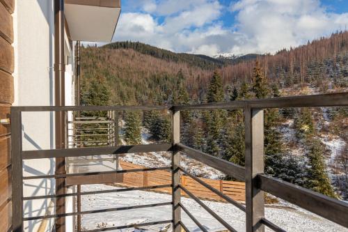 a balcony with a view of a snow covered forest at Konopka Forest Home & SPA in Bukovel