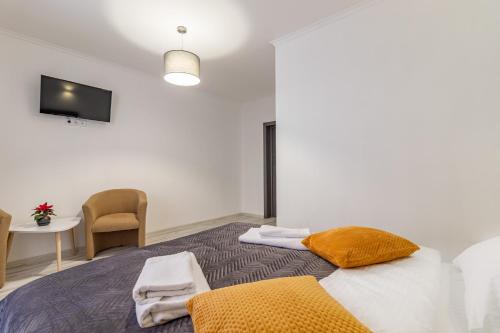 a bedroom with a bed with a chair and a table at Konopka Forest Home & SPA in Bukovel