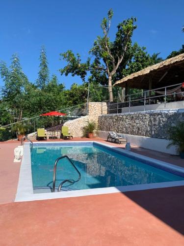 a swimming pool in front of a house at Bella Vista Vacation in Montego Bay