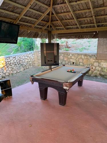 a pool table in a room with a tv at Bella Vista Vacation in Montego Bay