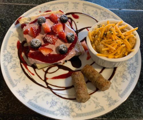 a plate of food with a sandwich and a bowl of cheese at Peace & Plenty Inn Bed and Breakfast Downtown St Augustine-Adults Only in Saint Augustine