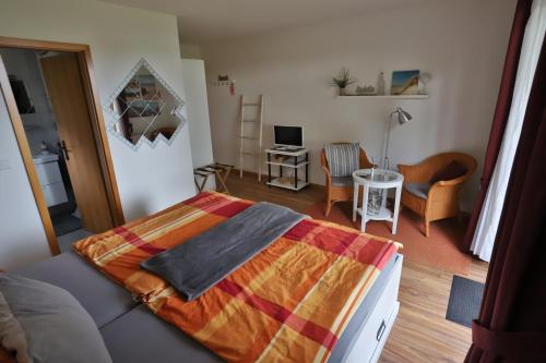 a bedroom with a bed and a living room at Bellevue in Malente