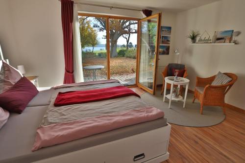 a bedroom with a bed and a sliding glass door at Bellevue in Malente