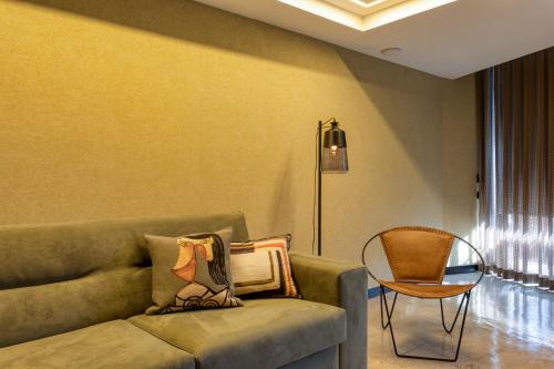 a living room with a couch and a chair at Well Hotel & Spa in Maceira