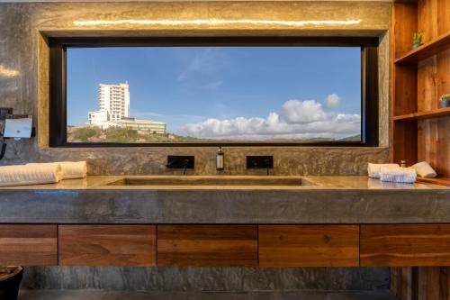 a large window in a bathroom with a large sink at Well Hotel & Spa in Maceira