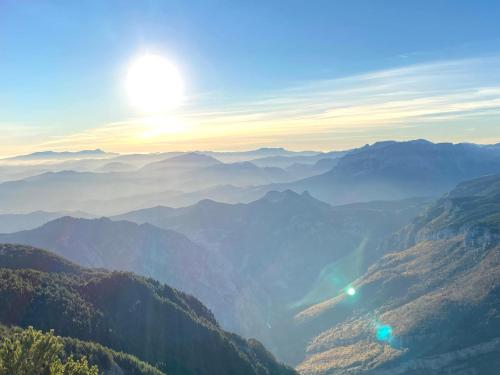 a view of a mountain valley with the sun in the sky at Casa Campolé in San Juan de Plan