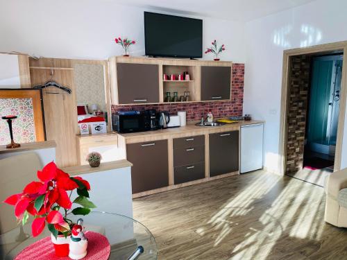 a kitchen with a table with a tv on top at Casa Elena in Sibiu