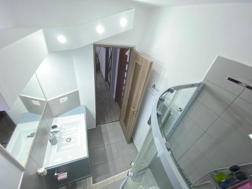 a small bathroom with a sink and a mirror at Apartament Sulina in Sulina