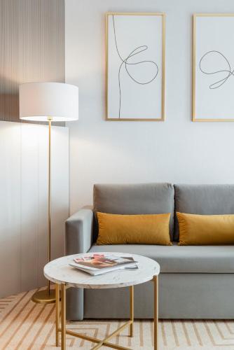a living room with a couch and a table at Crystal Mountain Hotel Wisła in Wisła
