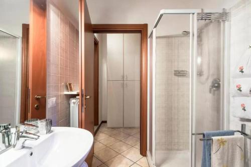 a bathroom with a shower and a sink and a tub at Casa Vacanze Rosalba in Ferraro di Monte Baldo
