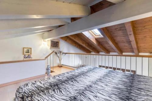 a bedroom with a large bed in a room with wooden ceilings at Casa Vacanze Rosalba in Ferraro di Monte Baldo