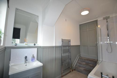 a bathroom with a shower and a sink and a mirror at Maytree 2 Bed Apartment - STAYSEEKERS in Salisbury