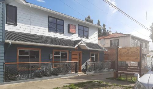 a building with a bench in front of it at Casa Lucy in Puerto Natales