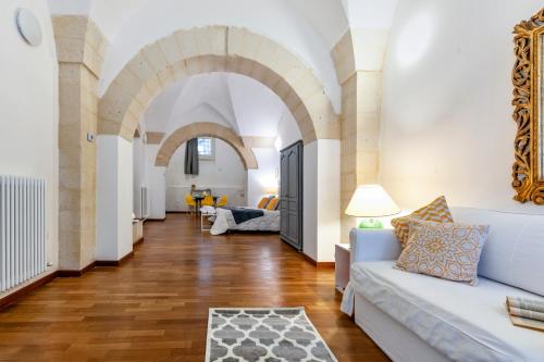 a living room with arches and a white couch at Yellow Loft - Old Town Apartment SIT in Lecce