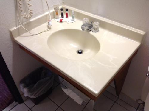 a sink in a bathroom with a white counter at Super 8 by Wyndham Winchester VA in Winchester