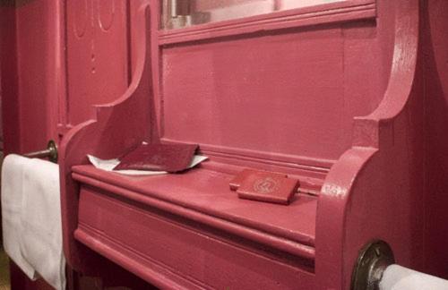 a red door with a book on top of it at Hotel Colombo Genova in Genoa