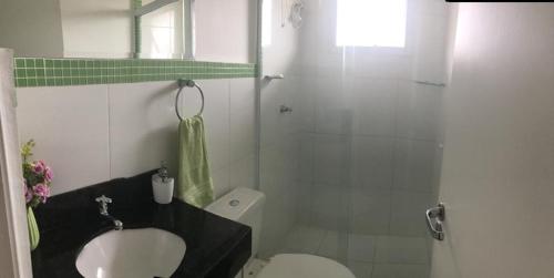 e bagno con servizi igienici, lavandino e doccia. di Apto nas montanhas a Campos do Jordão