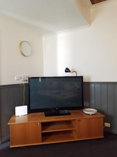 a flat screen tv sitting on top of a wooden entertainment center at Sheffield Nine-Nine in Sheffield