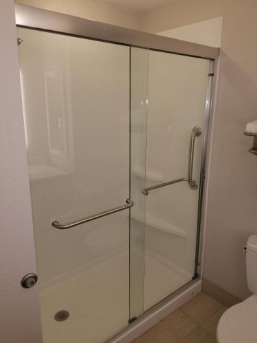 a glass shower door in a bathroom with a toilet at Holiday Inn Express Rolla by IHG in Rolla
