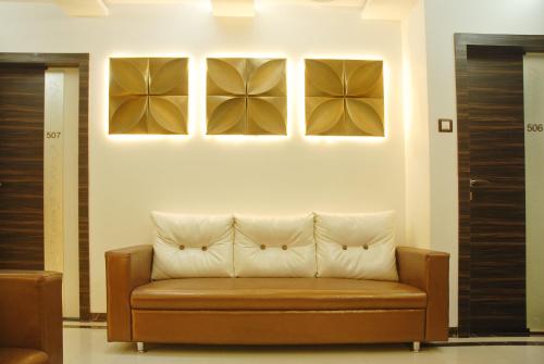 a couch sitting in a room with a wall at Hotel City View in Navi Mumbai