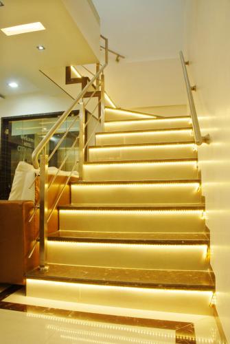 a set of stairs in a building with lights at Hotel City View in Navi Mumbai