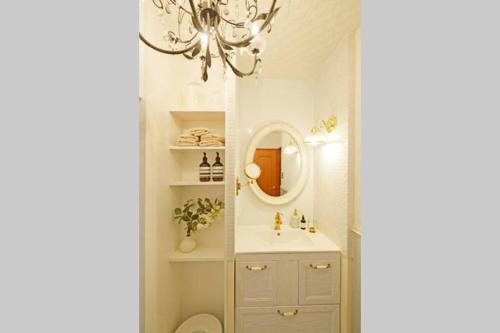 a bathroom with a sink and a mirror at Meee Shinjuku in Tokyo