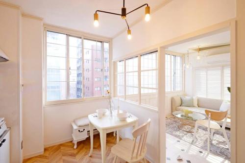 a living room with a table and a couch at Meee Shinjuku in Tokyo