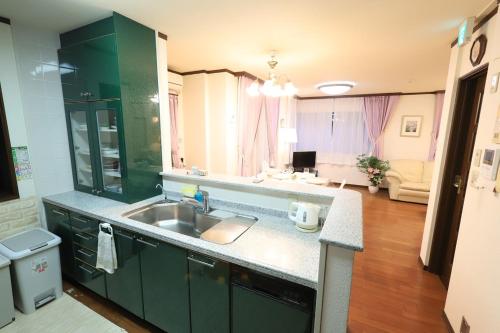 a kitchen with a sink and a living room at RKT4bedroom ForFamily 30mins Shibuya and Azabu in Tokyo