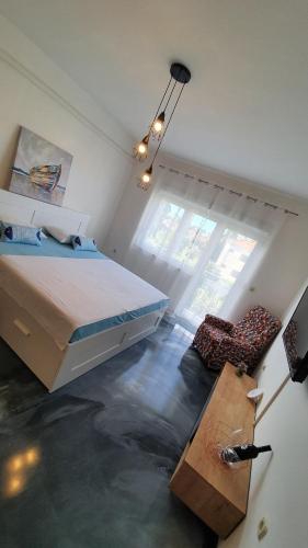a bedroom with a large bed and a floor with water at Slow motion in Kaštela