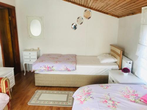 a bedroom with two beds and a mirror at Eren Villa in Sapanca