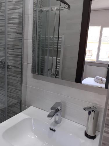 a white bathroom with a sink and a mirror at Giosam Bed & Breakfast di Raimondo Isabelle in Pozzilli