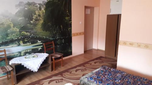 a room with a table and a table and chairs at Napsugár Panzió in Vác