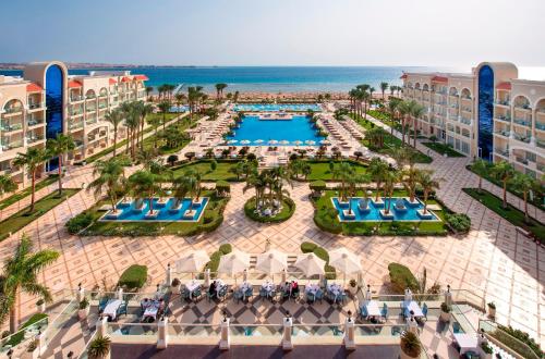 an aerial view of a resort with a pool and the ocean at Premier Le Reve Hotel & Spa Sahl Hasheesh - Adults Only 16 Years Plus in Hurghada