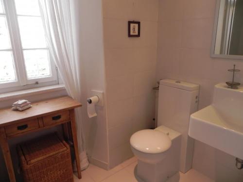 a white bathroom with a toilet and a sink at Villa By The Sea Near Dubrovnik in Cavtat