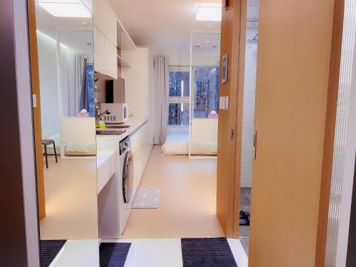 a kitchen with a hallway leading to a living room at Shine Hotel Incheon Airport in Incheon