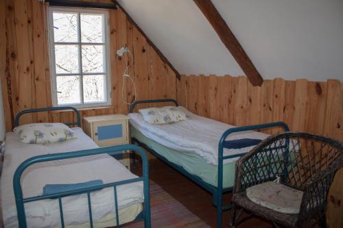 1 dormitorio con 2 literas y 1 silla en Kooli Kopli Holiday Homes, en Myustelʼ