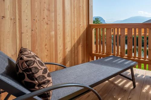 a wooden deck with a bench and a table at Apt Lärche - Nockerhof in Andrian