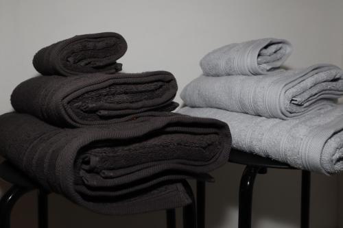 a pile of towels sitting on top of a stool at Modern appartement met uniek zeezicht in Koksijde