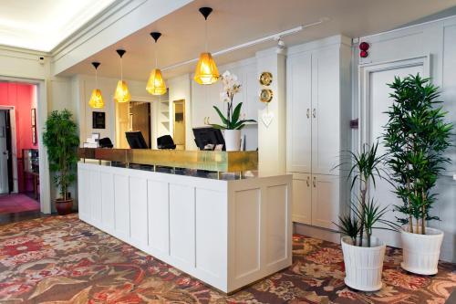a salon with a reception counter in a room with plants at Best Western Hotel Baltic in Sundsvall
