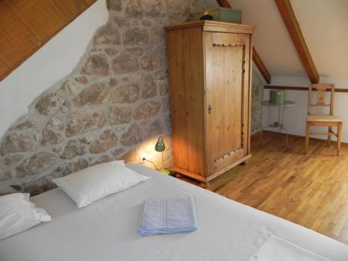 a bedroom with a bed and a stone wall at Villa By The Sea Near Dubrovnik in Cavtat