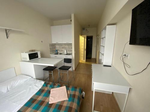 a small room with a bed and a kitchen at BYSmartHouse in Kyiv