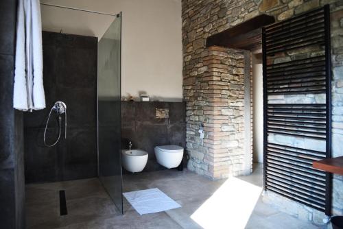 a bathroom with a glass shower and a toilet at Borgo Stanzano in Zocca