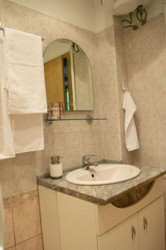 a bathroom with a sink and a mirror at Midtown Place Apartment DORIS 1 with garage in Plovdiv