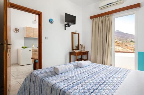 a bedroom with a bed and a large window at marina beach in Livadia