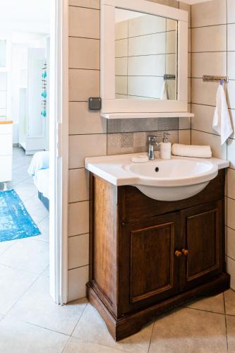 a bathroom with a sink and a mirror at Villa Tani in Agios Georgios